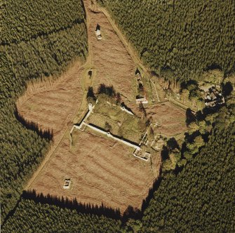 Oblique aerial view of Auchernoch centred on the remains of a country house and its grounds including a mill building, taken from the SW.