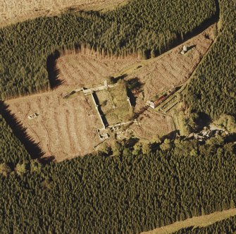 Oblique aerial view of Auchernoch centred on the remains of a country house and its grounds including a mill building, taken from the S.