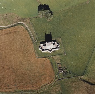 Oblique aerial view of Corgarff castle centred on the tower-house with the remains of a pond, farmstead and the cropmarks of a building adjacent, taken from the SSW.