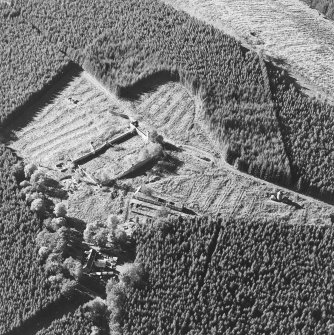 Oblique aerial view of Auchernoch centred on the remains of a country house and its grounds including a mill building, taken from the E.