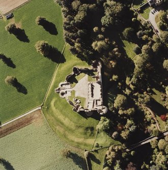 Oblique aerial view of Kildrummy Castle centred on the remains of a castle, taken from the ENE.