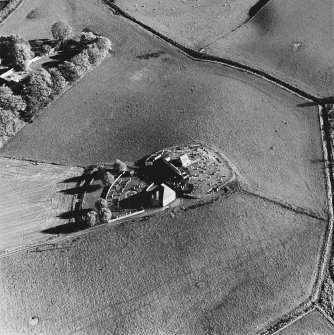 Oblique aerial view of Kildrummy, St Bride's Chapel and Well centred on the chapel with a possible motte and churchyard adjacent, taken from the NW.