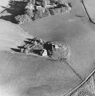 Oblique aerial view of Kildrummy, St Bride's Chapel and Well centred on the chapel with a possible motte and churchyard adjacent, taken from the W.