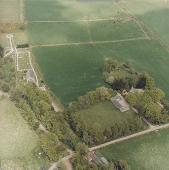 Oblique aerial view of the manse with the church adjacent, taken from the SW