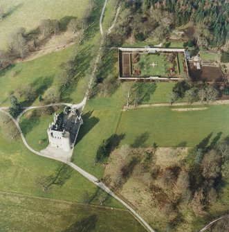 Oblique aerial view of the tower-house with walled garden adjacent, taken from the SSE.
