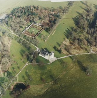 Oblique aerial view of the tower-house with walled garden adjacent, taken from the SW.