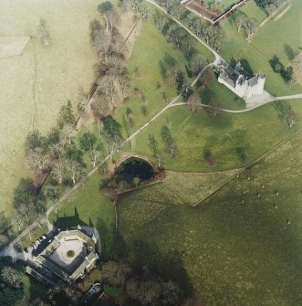 Oblique aerial view centred on the tower-house with the stable block adjacent, taken from the SW.