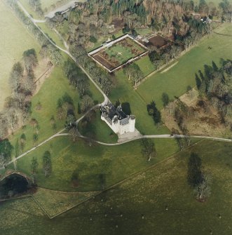 Oblique aerial view of the tower-house with walled garden adjacent, taken from the SSW.