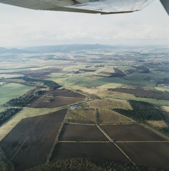 General oblique aerial view looking over the Greenmoss farmsteading towards Bennachie, taken from the SE.