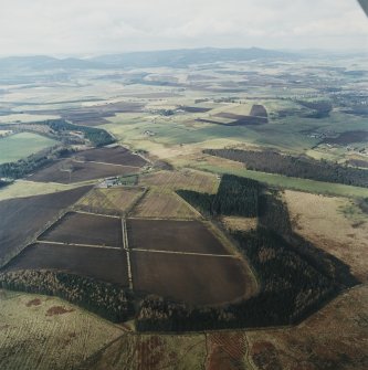 General oblique aerial view looking over the Greenmoss farmsteading towards Bennachie, taken from the SE.