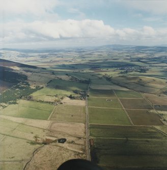 General oblique aerial view looking across Rhynie and upper Strathbogie towards the Garioch, taken from the WNW.