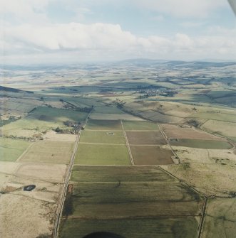 General oblique aerial view looking across Rhynie and upper Strathbogie towards the Garioch, taken from the W.