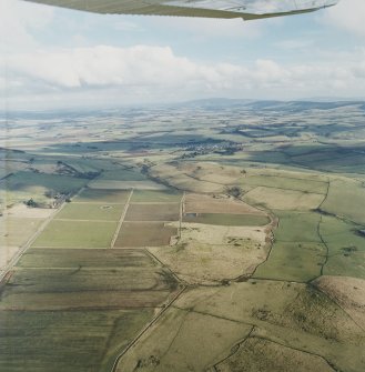 General oblique aerial view looking across Rhynie and upper Strathbogie towards the Garioch, taken from the W.