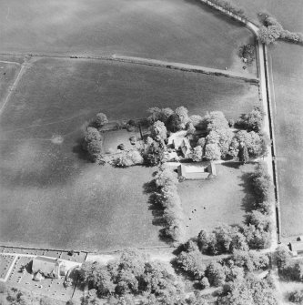 Oblique aerial view of the manse with the church adjacent, taken from the WNW