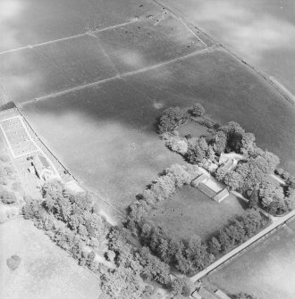 Oblique aerial view of the manse with the church adjacent, taken from the W