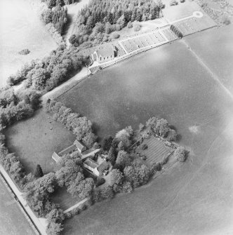 Oblique aerial view of the manse with the church adjacent, taken from the SSE