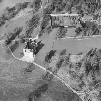 Oblique aerial view of the tower-house with walled garden adjacent, taken from the S.