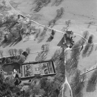 Oblique aerial view of the tower-house with walled garden adjacent, taken from the N.