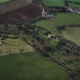 Oblique aerial view centred on the castle, garden, walls, cottage and lodge with the farmsteading adjacent, taken from the E.