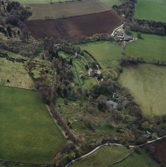 Oblique aerial view centred on the castle, garden, walls, cottage and lodge with the burial-ground and farmsteading adjacent, taken from the ENE.