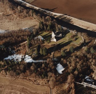 Oblique aerial view centred on the tower-house taken from the SSE.