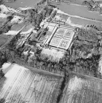 Oblique aerial view centred on the country house and garden, taken from the SSE.