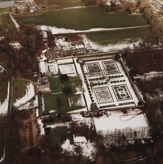 Oblique aerial view centred on the country house and garden, taken from the SSW.