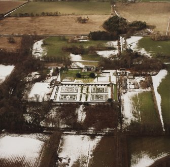 Oblique aerial view centred on the country house and garden, taken from the E.