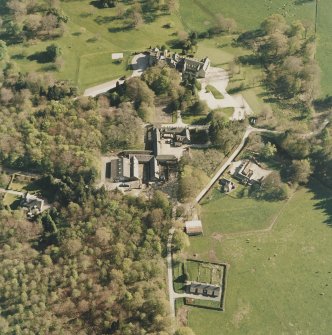 Oblique aerial view centred on the country house and farmsteading, taken from the NNW.