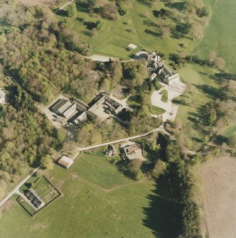 Oblique aerial view centred on the country house and farmsteading, taken from the NW.