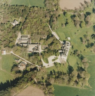 Oblique aerial view centred on the country house and farmsteading, taken from the W.