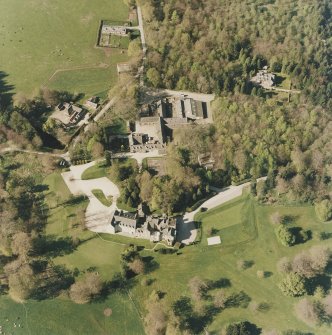 Oblique aerial view centred on the country house and farmsteading, taken from the S.