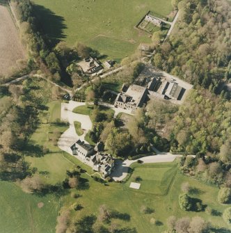 Oblique aerial view centred on the country house and farmsteading, taken from the SSE.