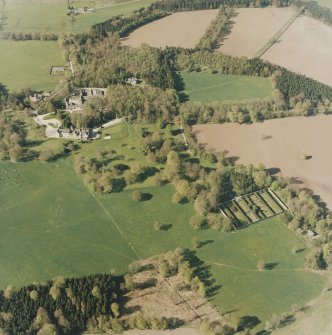 Oblique aerial view of the country house, farmsteading and walled garden, taken from the S.