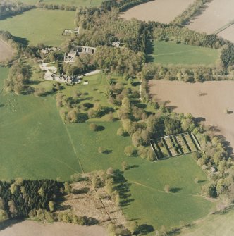 Oblique aerial view of the country house, farmsteading and walled garden, taken from the SE.