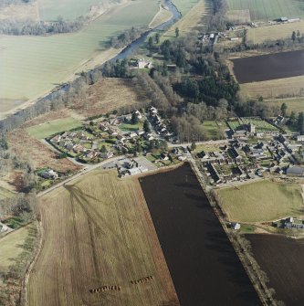 Oblique aerial view centred on Monymusk village with the tower-house in the background, taken from the WNW.