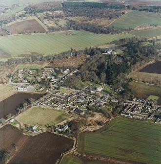 Oblique aerial view centred on Monymusk village with the tower-house in the background, taken from the SW.