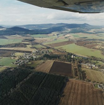 General oblique aerial view looking across Monymusk village towards Bennachie, taken from the SSE.