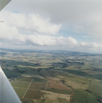 General oblique aerial view looking across Rhynie and upper Strathbogie towards the Garioch, taken from the W.