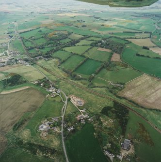 Oblique aerial view of tower-house, country house, home farm and policies, taken from the SE.