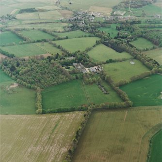 Oblique aerial view of tower-house, country house, home farm and policies, taken from the N.
