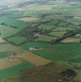 Oblique aerial view of tower-house, country house, home farm and policies, taken from the NNW.