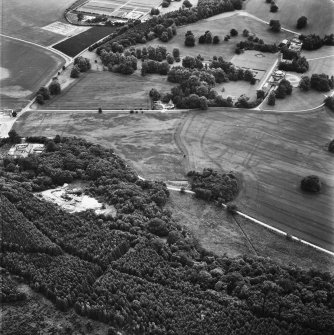 Oblique aerial view from East North East of Gordon Castle estate (after demolitions), including house, farm, laundry cottages, kennels and cropmarks