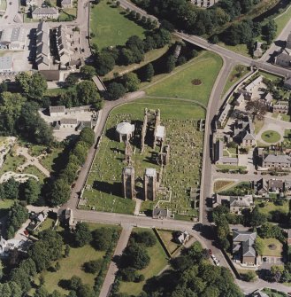 Oblique aerial view centred on the remains of the cathedral and Chapter House, taken from the W.