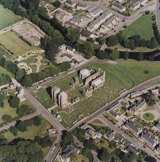Oblique aerial view centred on the remains of the cathedral and Chapter House, taken from the SW.
