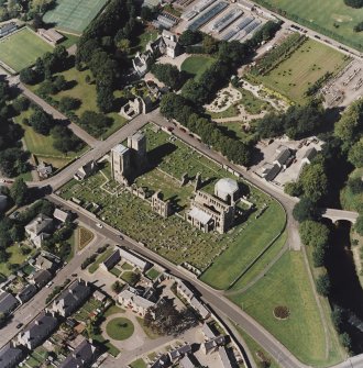 Oblique aerial view centred on the remains of the cathedral and Chapter House, taken from the SE.