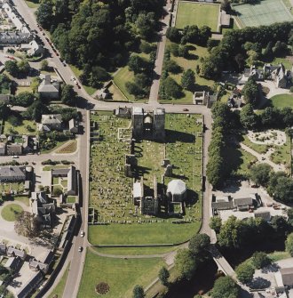 Oblique aerial view centred on the remains of the cathedral and Chapter House, taken from the E.