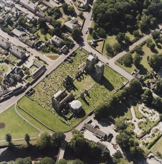 Oblique aerial view centred on the remains of the cathedral and Chapter House, taken from the NE.