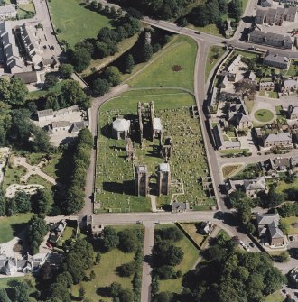 Oblique aerial view centred on the remains of the cathedral and Chapter House, taken from the W.