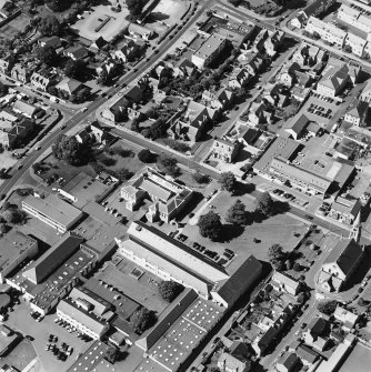 Oblique aerial view centred on the college with the church adjacent, taken from the ESE.